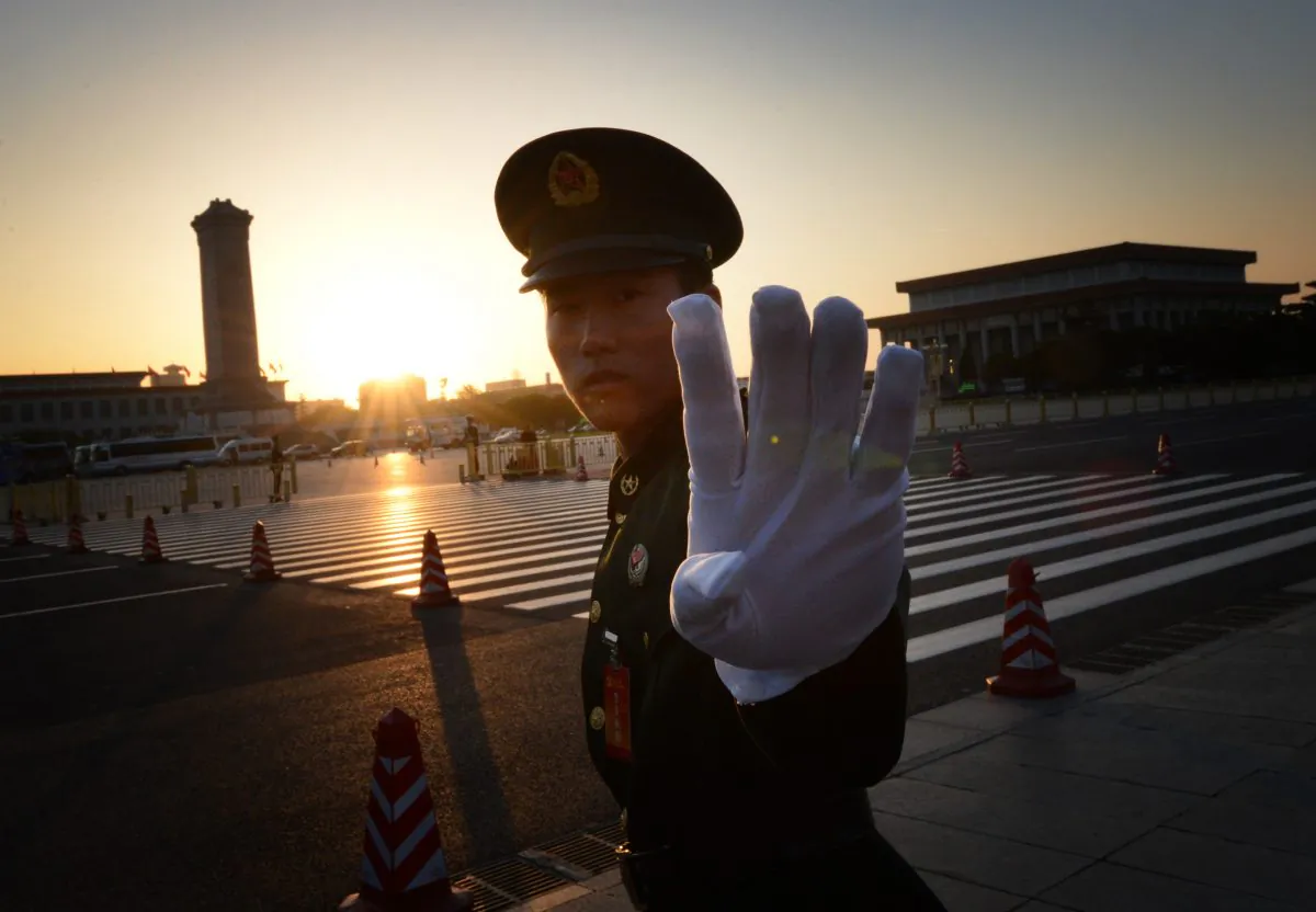 A Chinese paramilitary policeman reacts outside the opening session of the Chinese Communist Party's five-yearly Congress at the Great Hall of the People in Beijing on Nov. 8, 2012. (MARK RALSTON/AFP/Getty Images)