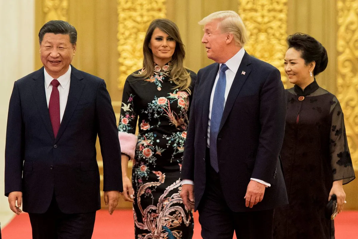 United States President Donald Trump speaks to Chinese leader Xi Jinping, as First Lady Melania Trump and Xi's wife Peng Liyuan look on, at the Great Hall of the People in Beijing on Nov. 9, 2017. (Jim Watson/AFP/Getty Images)