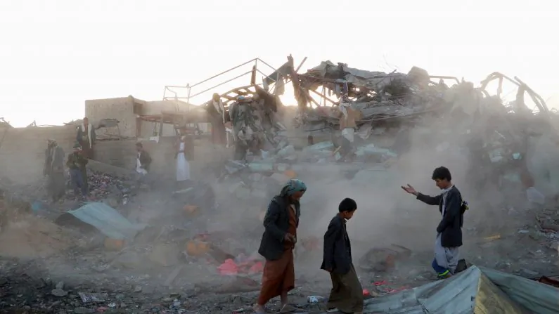 People walk at the site of an air strike in the northwestern city of Saada, Yemen on Nov. 1, 2017. (Naif Rahma/Reuters)