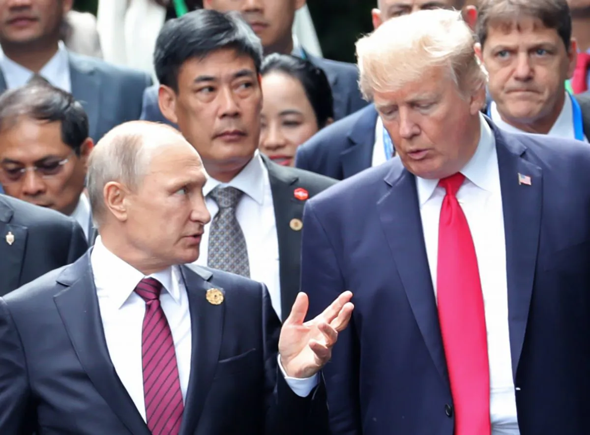 President Donald Trump and Russia's President Vladimir Putin talk as they make their way to take the 'family photo' during the Asia-Pacific Economic Cooperation (APEC) leaders' summit in the Danang, Vietnam, on Nov. 11, 2017. (Mikhail Klimentyev/AFP/Getty Images)