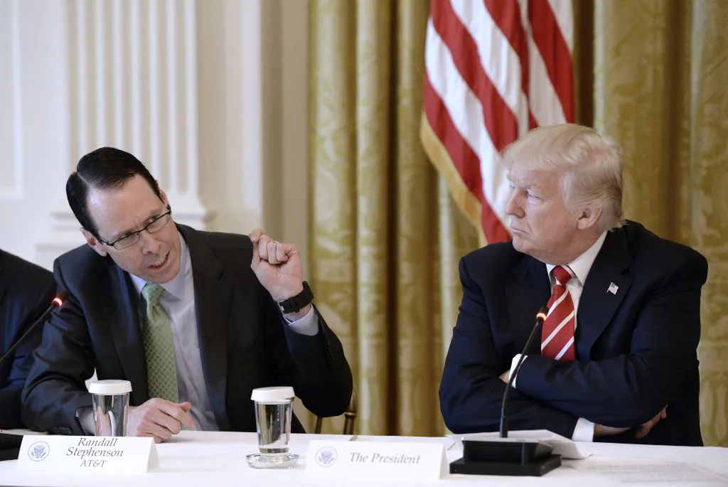 AT&T CEO Randall Stephenson (L) speaks as President Donald Trump looks on during the American Leadership in Emerging Technology Event in the East Room of the White House in Washington, on June 22, 2017. Stephenson refuted speculations on Nov. 9 that Trump might personally be trying to interfere with AT&T’s acquisition of CNN’s parent company Time Warner. (Olivier Douliery-Pool/Getty Images)