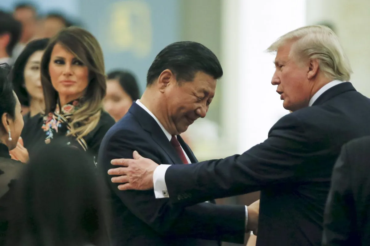 Chinese leader Xi Jinping (C) and President Donald Trump (R) greet each other as they attend a state dinner, along with Xi's wife, Peng Liyuan (L), and First Lady Melania Trump (2nd L), in Beijing on Nov. 9, 2017. (Thomas Peter/Pool/Getty Images)