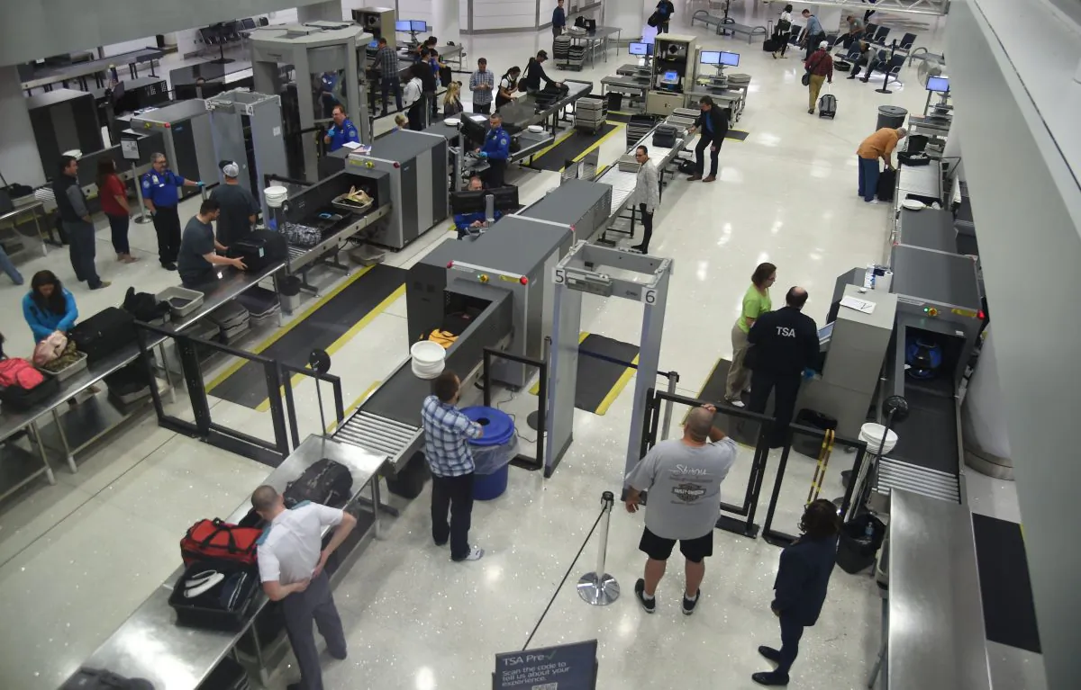 TSA officers inspect airline passengers before they board their flights, at Lambert, St. Louis International Airport in St Louis, Mo., on Oct. 10, 2016. (Robyn Beck/AFP/Getty Images)