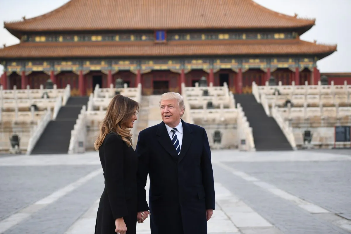 President Donald Trump holds hands with First Lady Melania Trump in the Forbidden City after arriving in Beijing on Nov. 8, 2017. (JIM WATSON/AFP/Getty Images)