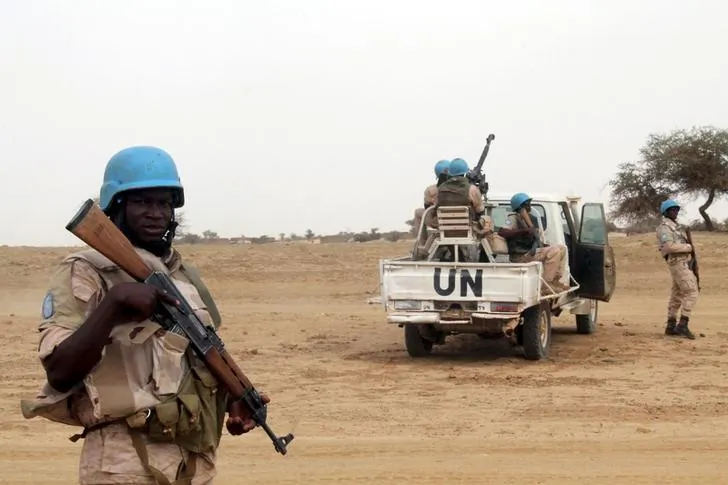U.N. peacekeepers stand guard in the northern town of Kouroume, Mali, May 13, 2015. Kourome is 11 miles south of Timbuktu.
 (REUTERS/Adama Diarra)