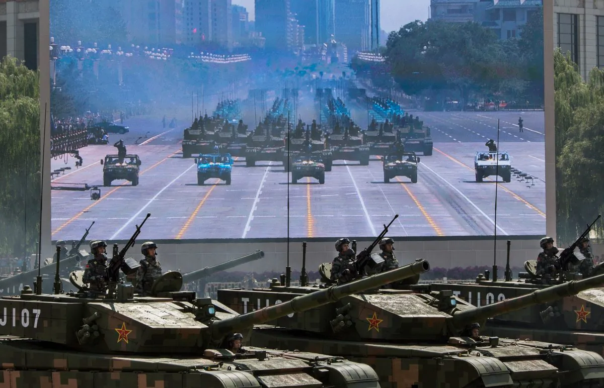 Chinese soldiers ride in tanks as they pass in front of Tiananmen Square and the Forbidden City during a military parade in Beijing, China, on Sept. 3, 2015. (Kevin Frayer/Getty Images)