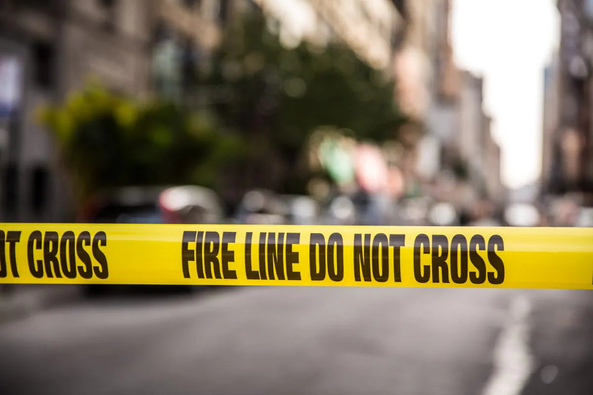 Police tape in a stock photo (Benjamin Chasteen/The Epoch Times)