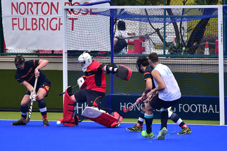 HKCC goalie just gets a toe to this penalty corner strike by HKFC in the HKHA Premier League on Sunday Nov 12, 2-17. (Bill CVox/Epoch Times)