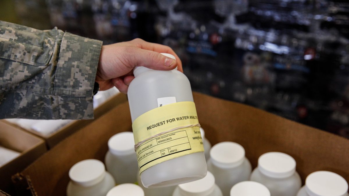 A National Guard soldiers looks at a bottle containing contaminated water headed for lab testing, January 21, 2016 in Flint, Michigan. (Sarah Rice/Getty Images)