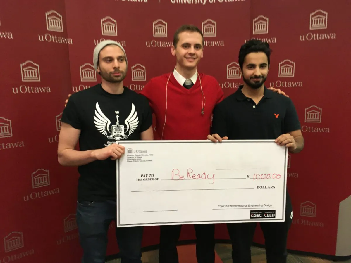 BeReady co-founders (L–R) Jad Slim, Jesse Ward-Bond, and Amer Abdulkader hold a check for $1,000 as first-prize for winning Startup Weekend Ottawa on Nov. 19, 2017. (Rahul Vaidyanath/The Epoch Times)