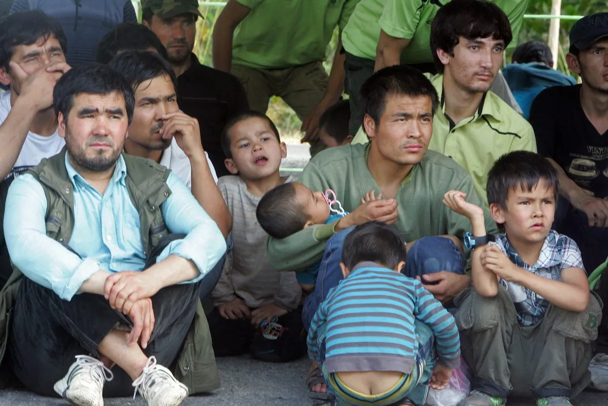 Asylum seekers sit before boarding trucks as Thai Immigration officials escort them to a court in Songkhla, southern Thailand on March 15, 2014. Thailand on March 15 sentenced dozens of asylum seekers thought to be from China's Uighur minority for illegal entry, an official said, despite a US appeal for their protection.
(Tuwaedaniya MERINGING/AFP/Getty Images)