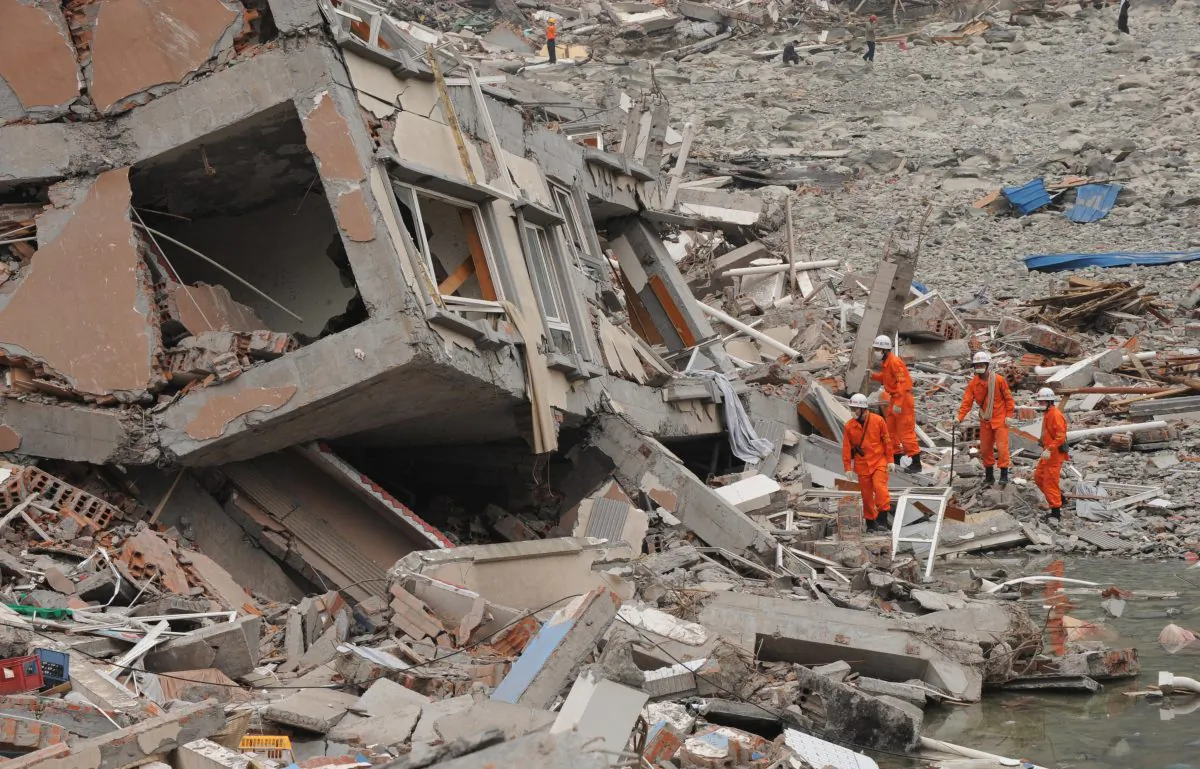 Rescue workers prepare to search a collapsed building at the earthquake damaged town of Beichuan in Sichuan Province on May 17, 2008. (Mark Ralston/AFP/Getty Images)