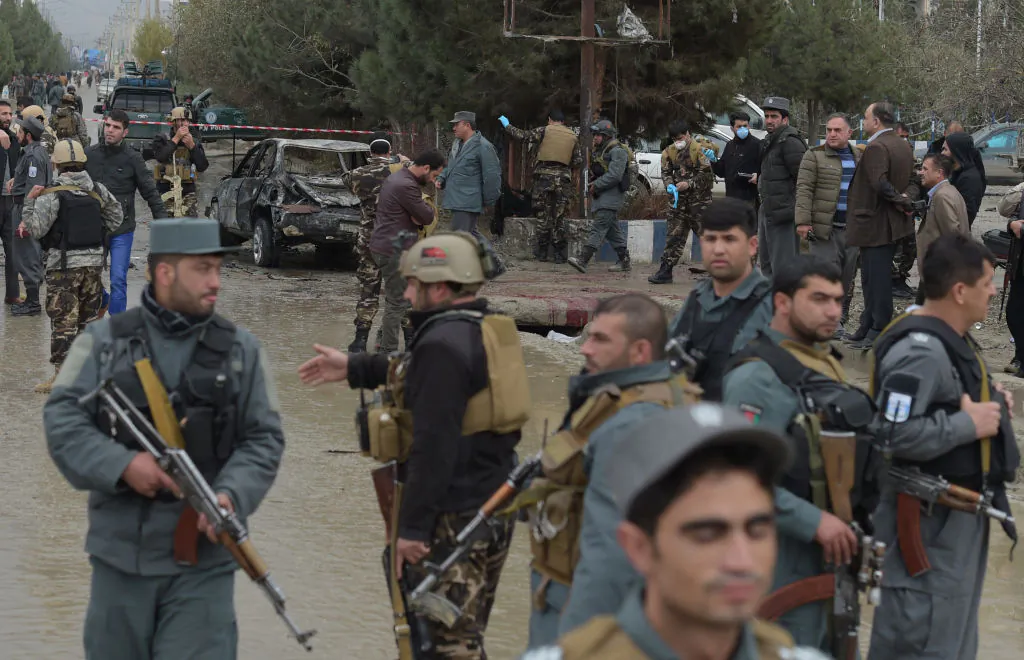Afghan security personnel gather next to a vehicle, which was used in a suicide bombing outside a wedding hall in Kabul on Nov. 16, 2017. A suicide attacker blew himself up outside a wedding hall in Kabul killing at least nine people, officials said Nov. 16, in an apparent attempt to strike at a political gathering underway inside.       (Shah Marai/AFP/Getty Images)