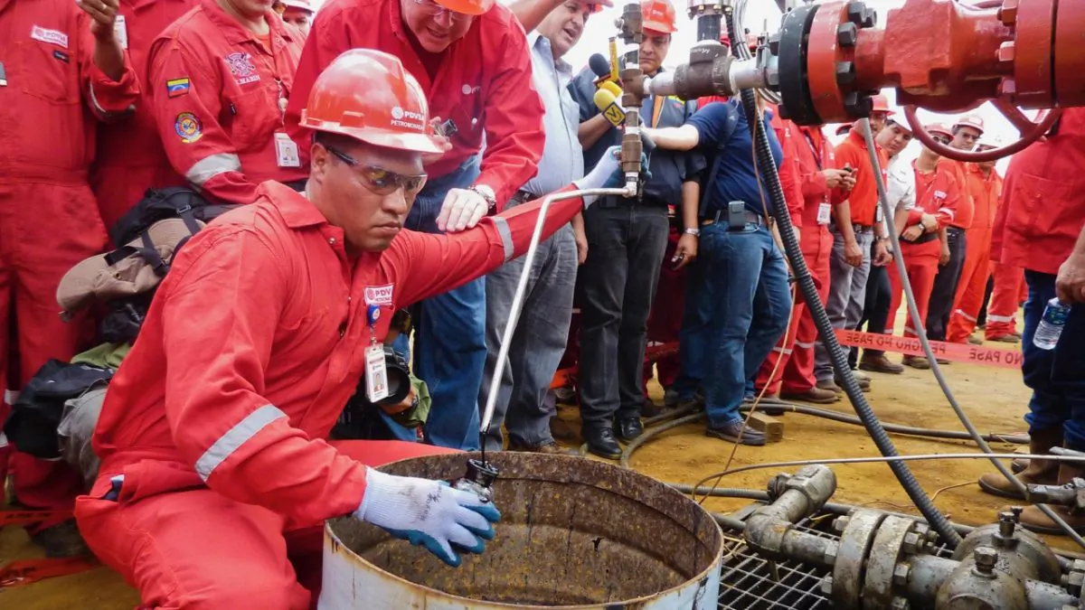 A technician takes a sample of crude oil from a well operated by Venezuela's state-owned oil company PDVSA in Morichal, Venezuela. (Ramon Sahmkow/AFP/Getty Images)