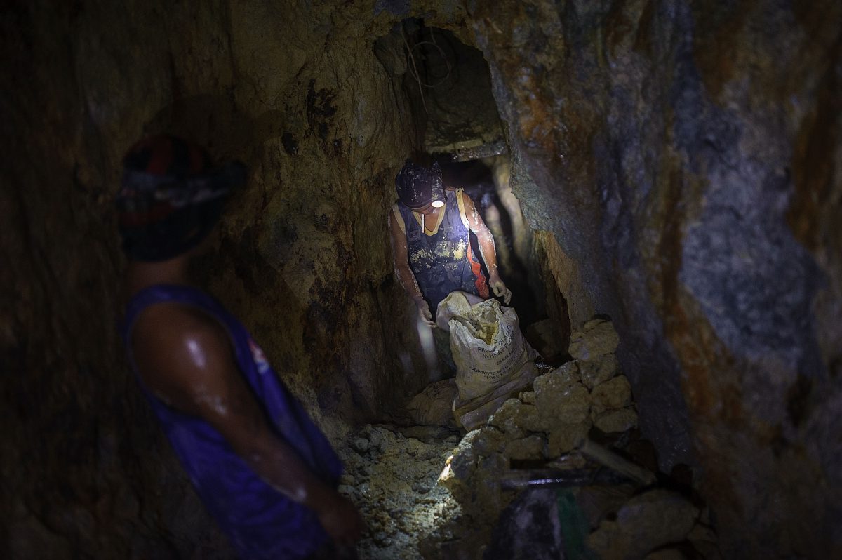 A gold miner tests the weight of a sack full of raw ore before carrying it to a processing station on the surface, on April 22, 2014 in Pinut-An, Philippines. Gold mining is the primary source of income for residents of Pinut-An, surpassing fishing as the leading form of employment. In 2014, an average gold miner earned roughly $180 per month for working seven days a week, while the mine owner expected to earn up to ten times that amount. (Luc Forsyth/Getty Images)