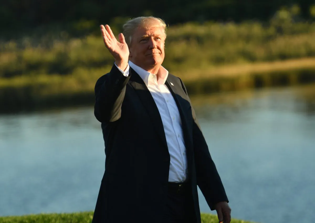 President Donald Trump waves to the crowd as he participates in the trophy presentation of the President's Cup golf championship at Liberty National Golf Club in Jersey City, New Jersey, on Oct. 1, 2017. (NICHOLAS KAMM/AFP/Getty Images)