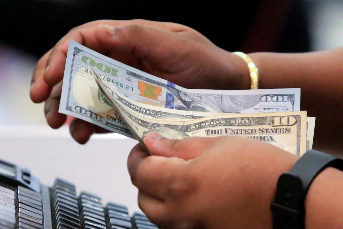 A cashier handles money in Macy's Herald Square in Manhattan, New York.  Entrepreneus can only make money if they help consumers solvea 
 problem. (Reuters/Andrew Kelly)