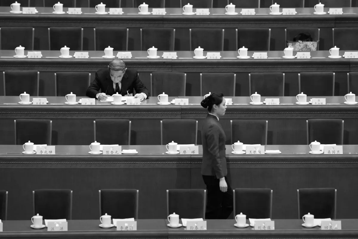 Chinese economist Li Yining sits among empty chairs at the People's Political Consultative Conference held at the Great Hall of the People in Beijing, on March 3, 2013.       (STR/AFP/Getty Images)