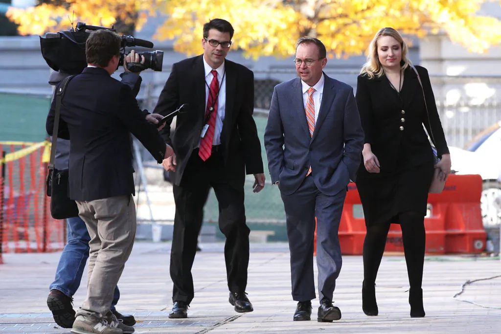 Director of the Office of Management and Budget Mick Mulvaney (C), President Donald Trump's pick for acting director of the Consumer Financial Protection Bureau, walks to the White House from the CFPB building on his first day of work in Washington on Nov. 27, 2017. (Alex Wong/Getty Images)
