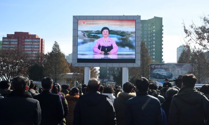 Pyongyang residents watch a big screen near the Pyongyang Railway Station showing the news on the successful launch of the new intercontinental ballistic missile (ICBM) Hwasong-15 in Pyongyang on November 29, 2017. 
North Korean leader Kim Jong Un said on November 29 his country had achieved full nuclear statehood after successfully testing a new missile capable of hitting anywhere in the United States. (KIM WON-JIN/AFP/Getty Images)