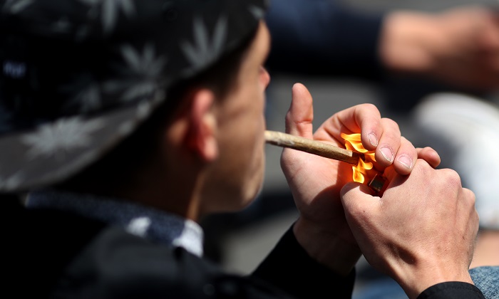 A man smokes marijuana in a file photo in Paris, France on May 14, 2016. (Kenzo Tribouillard/AFP/Getty Images)