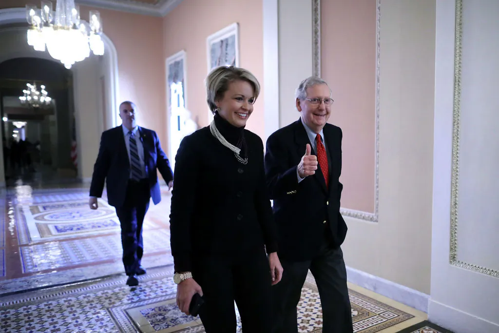 Senate Majority Leader Mitch McConnell (R-KY) gives a thumbs-up as he and his Director of Operations Stephanie Muchow head for the Senate floor at the U.S. Capitol in Washington, DC. on Dec. 1, 2017. Senate Republicans moved one step closer to delivering a tax reform bill to President Donald Trump before Christmas. (Chip Somodevilla/Getty Images)
