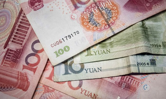 This undated photo shows Chinese 100 yuan, 10 yuan and one yuan notes in Beijing. (Fred Dufour/AFP/Getty Images)