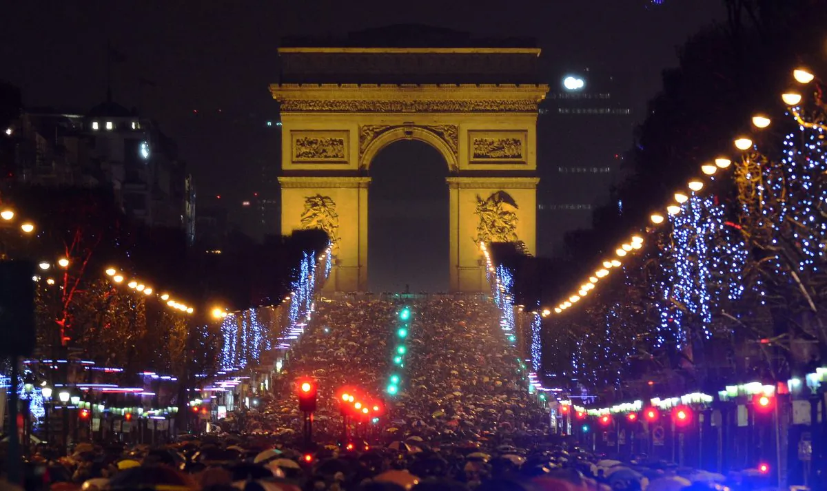People gather on the Champs-Elysees avenue in Paris to celebrate the New Year, late on December 31, 2012. AFP PHOTO / MIGUEL MEDINA (Photo credit should read MIGUEL MEDINA/AFP/Getty Images)