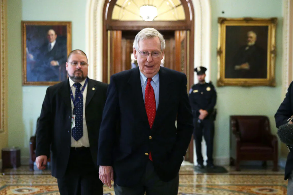 Senate Majority Leader Mitch McConnell (R-Ky.) walks from the Senate chamber to his office on Dec. 1. The Senate voted in favor of a Republican tax bill on Dec. 2. (ALEX WONG/GETTY IMAGES)