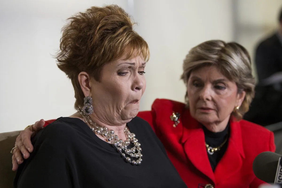 Attorney Gloria Allred (R) hugs Beverly Young Nelson as she reacts during a press conference on November 13, 2017, in New York. (EDUARDO MUNOZ ALVAREZ/AFP/Getty Images)