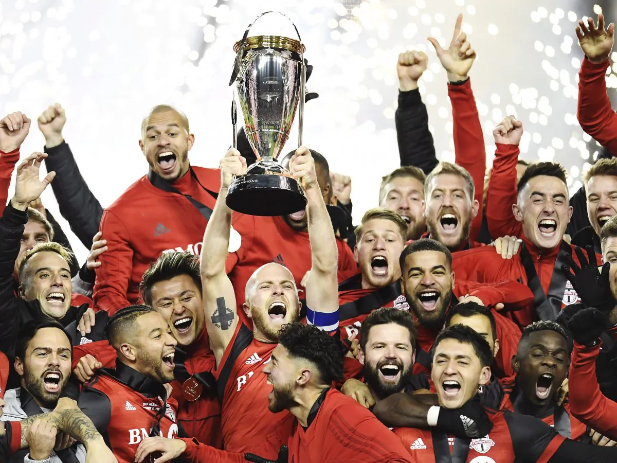 Toronto FC midfielder Michael Bradley raises the trophy as Toronto FC celebrate their victory over the Seattle Sounders in MLS Cup in Toronto on Dec. 9, 2017. (The Canadian Press/ Frank Gunn)
