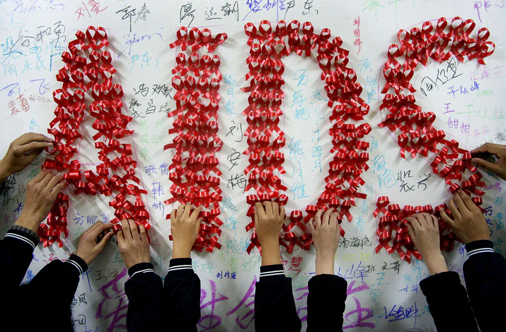 Chinese students use handmade red ribbons to form 'AIDS' one day ahead of the the World AIDS Day, at a school in Hanshan, east China's Anhui Province, on Nov. 30, 2009. (STR/AFP/Getty Images)