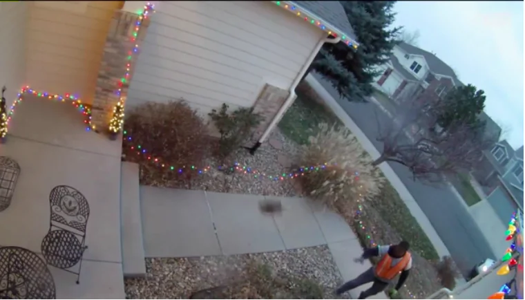 An Amazon delivery man chucks a package onto a Colorado homeowner's porch—twice. (Screenshot via KDVR)