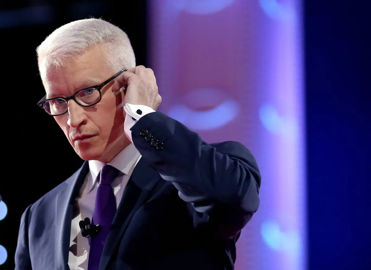 CNN anchor Anderson Cooper adjusts his earpiece during a commercial break while moderating a Democratic presidential debate sponsored by CNN at Wynn Las Vegas, on Oct. 13, 2015. (Joe Raedle/Getty Images)