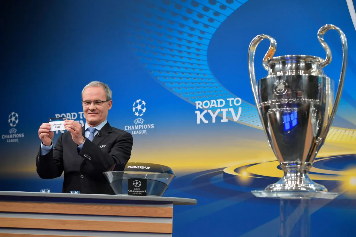 UEFA director of competitions Giorgio Marchetti shows the slip of Chelsea FC next to the Champions League trophy during the draw for the round of 16 of the UEFA Champions League football tournament at the UEFA headquarters in Nyon on Dec 11, 2017. (Fabrice Coffrini/AFP/Getty Images)