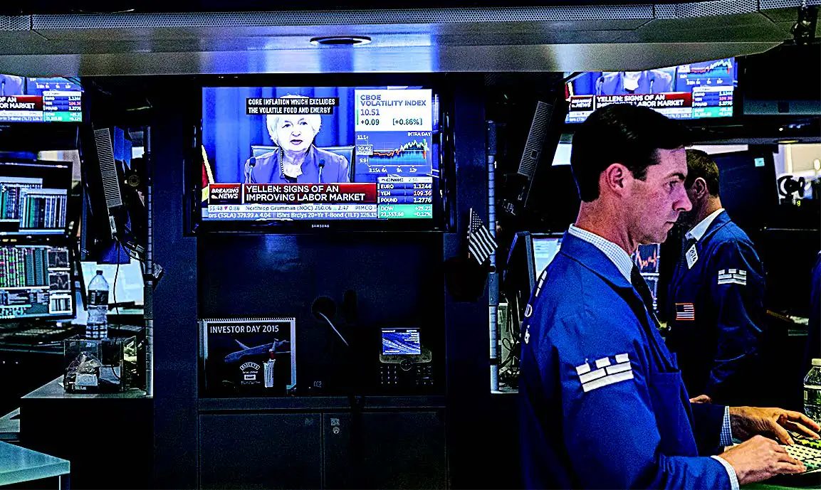 Traders work as Federal Reserve Chair Janet Yellen announces the Fed's decision to raise interest rates, on the floor of the New York Stock Exchange on June 14. (DREW ANGERER/GETTY IMAGES)