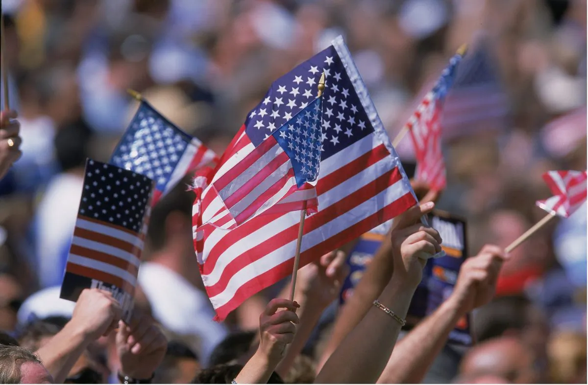 American Flags are waved by the crowd at the Rose Bowl in Pasadena, California, on Sept. 22, 2001. (Stephen Dunn/Allsport)