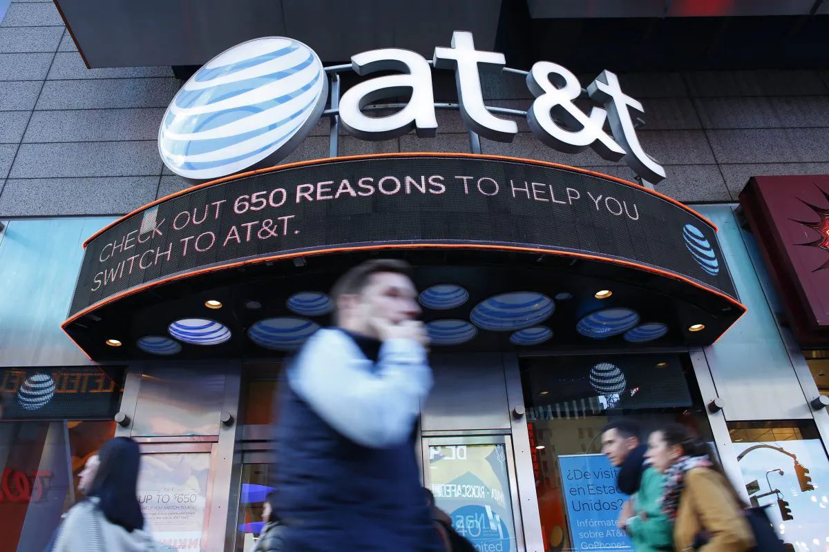 People walk past an AT&T store in New York on Oct. 23, 2016. 
(Kena Betancur/AFP/Getty Images)