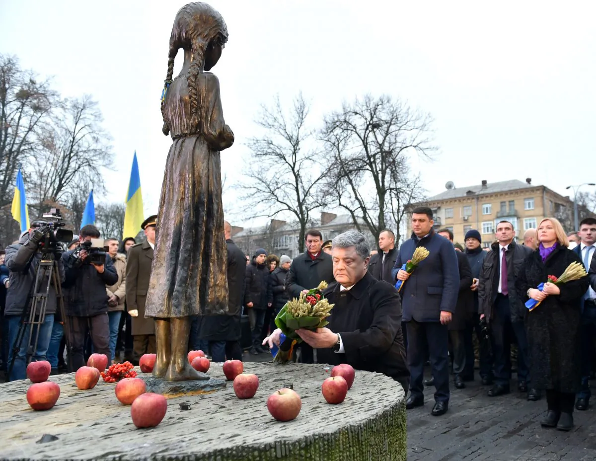 Ukrainian President Petro Poroshenko lays spikelets of wheat on the Holodomor memorial in Kiev on November 25 during a ceremony in memory of the victims of the Holodomor famine. The 1932-33 famine took place as harvests dwindled and Soviet leader Josef Stalin's police enforced the brutal communist policy of collectivizing agriculture by requisitioning grain and other foodstuffs. (GENYA SAVILOV/AFP/Getty Images)