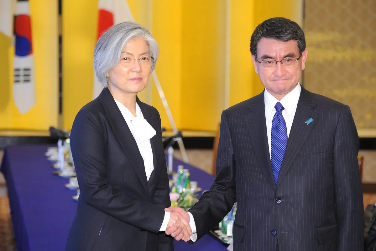 South Korean Foreign Minister Kang Kyung-wha (L) shakes hands with her Japanese counterpart Taro Kono as they attend the Japan-ROK Foreign Minister meeting at the Ministry of foreign affairs in Tokyo on Dec. 19, 2017.
(DAVID MAREUIL/AFP/Getty Images)
