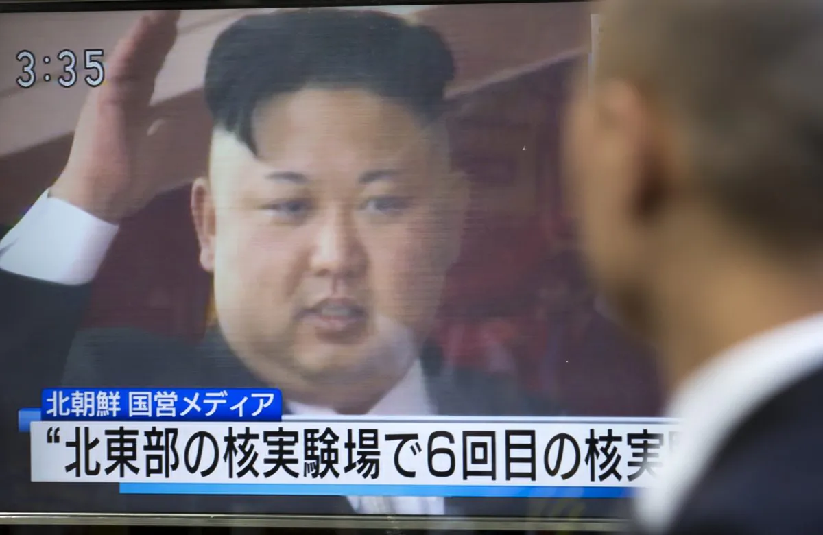 A pedestrian watches a monitor in Tokyo, Japan showing an image of North Korean leader Kim Jong-Un in a news report on Sept. 3, 2017. (Tomohiro Ohsumi/Getty Images)