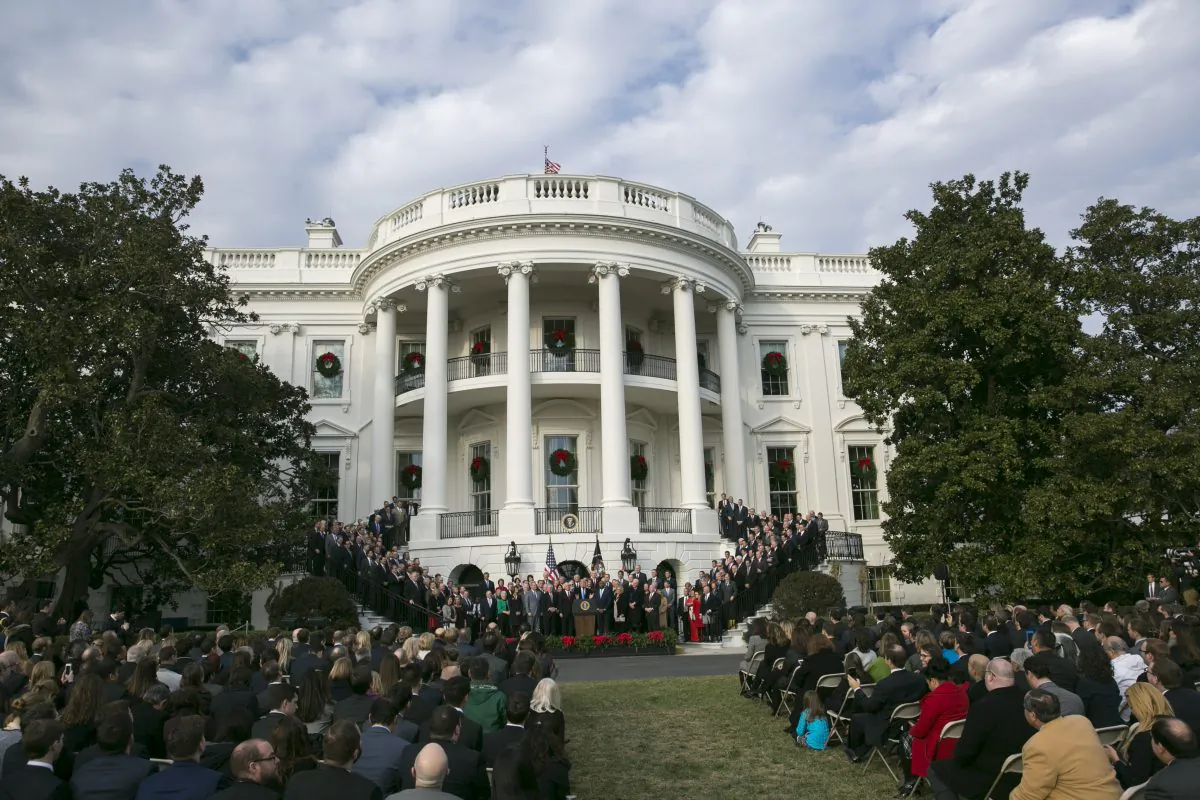 President Donald Trump celebrates the passage of the tax bill, while flanked by  Republican members of Congress, on the South Lawn of the White House in Washington, Dec. 20, 2017. (Samira Bouaou/The Epoch Times)