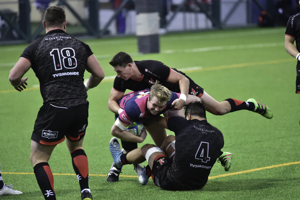 HKFC's Ben Wils gets stopped by Valley defenders during the HKRU Premiership match at HKFC on Saturday Dec16. (Bill Cox/Epoch Times)