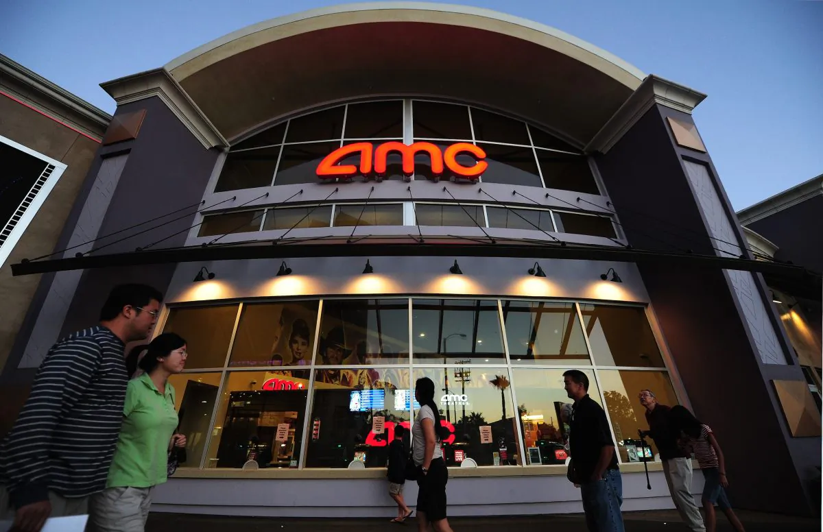 People walk past movie theaters of the U.S. cinema chain AMC Theatres in Monterey Park, east of downtown Los Angeles, California, on May 22, 2012. (Frederic J. Brown/AFP/Getty Images)