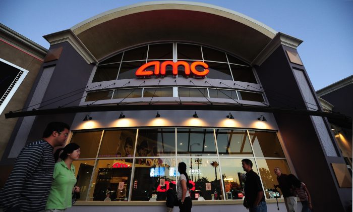 People walk past movie theaters of the U.S. cinema chain AMC Theatres in Monterey Park, east of downtown Los Angeles, California, on May 22, 2012. (Frederic J. Brown/AFP/Getty Images)