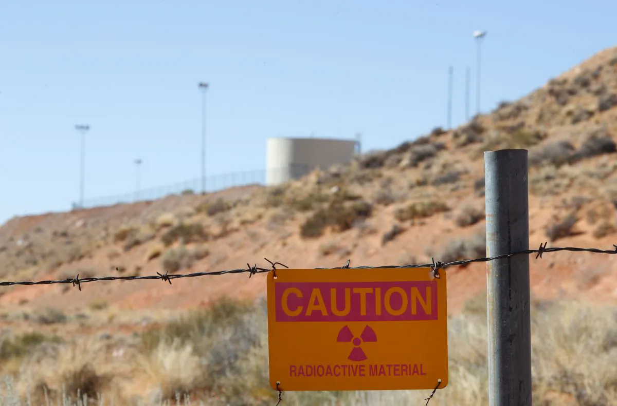 A warning sign against possible radioactivity hangs on fencing around Anfield's Shootaring Canyon uranium mill outside Ticaboo, Utah, on Oct. 27, 2017. (George Frey/Getty Images)