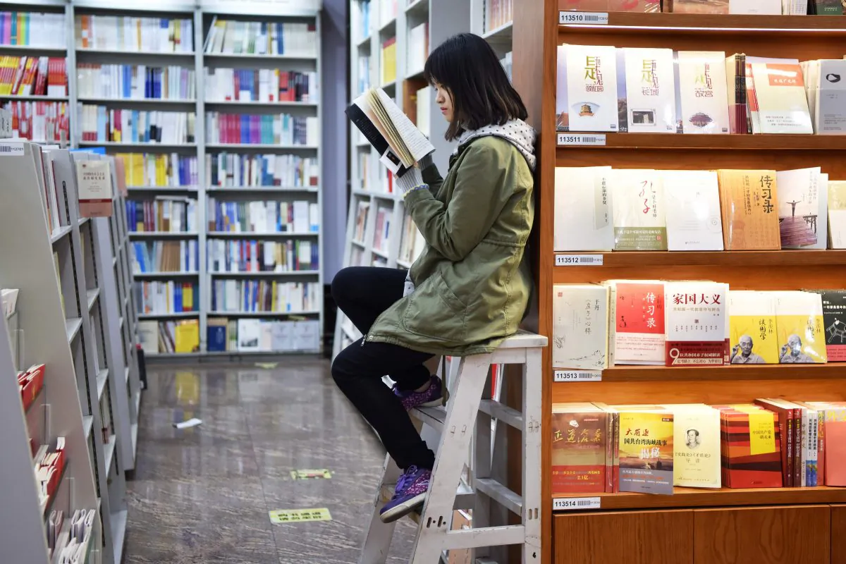 A woman reading a book at a bookstore in Beijing on Nov. 7, 2017.
(Greg Baker/AFP/Getty Images)
