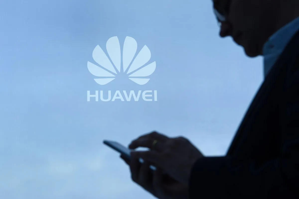A man uses his mobile phone at the Huawei stand during the Mobile World Congress on February 28, 2017 in Barcelona, Spain. (Lluis Gene/AFP/Getty Images)