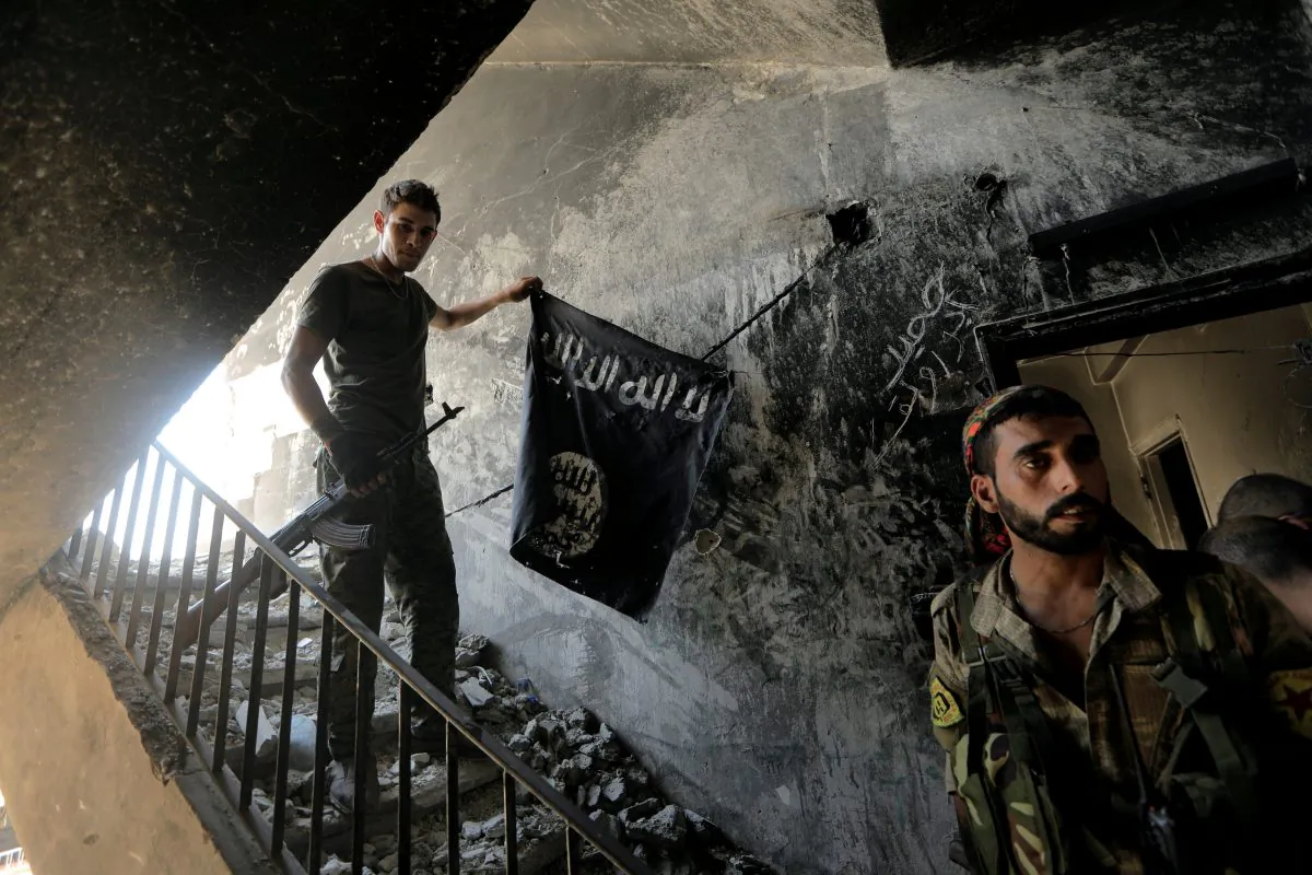 A member of the Syrian Democratic Forces calls his comrades during the fighting with Islamic State terrorists in Raqqa, Syria, Aug. 14, 2017.  (Reuters/Zohra Bensemra/File Photo)