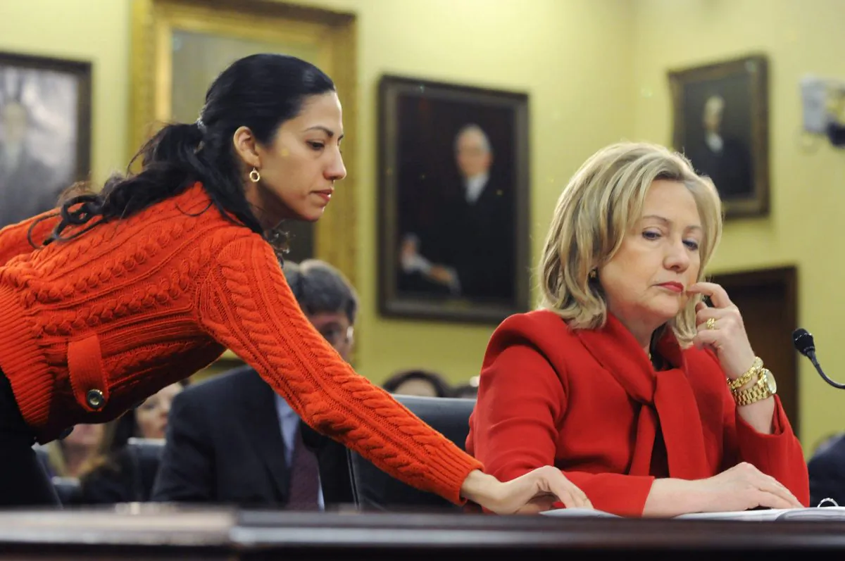 Then Secretary of State Hillary Clinton (R) receives a note from her aide Huma Abedin (L) as she testifies about the State Department's budget during a hearing of the State, Foreign Operations and Related Programs Subcommittee of the House Appropriations Committee on March 10, 2011. (Jonathan Ernst/Getty Images)